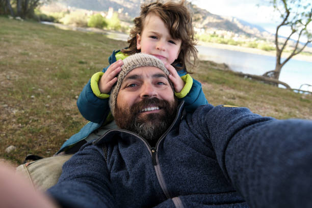 istock Happy father and son taking selfie in park 2155758727