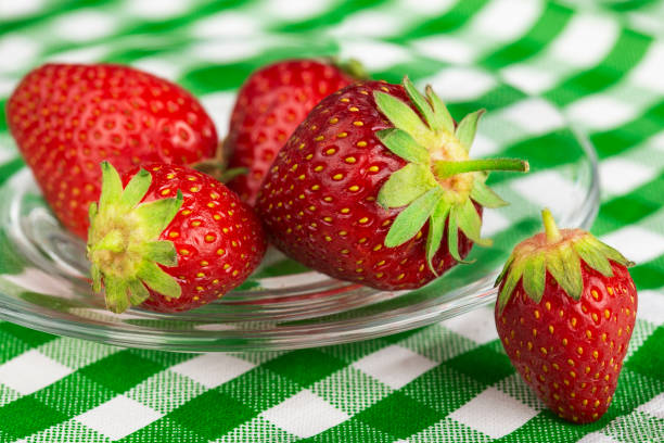 red strawberries closeup in a glass dish