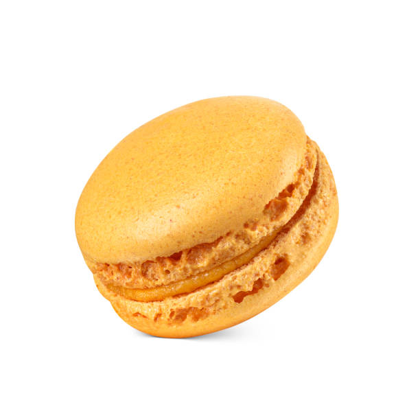 One mango orange macaron isolated on white. Sweet French sandwich cookie.