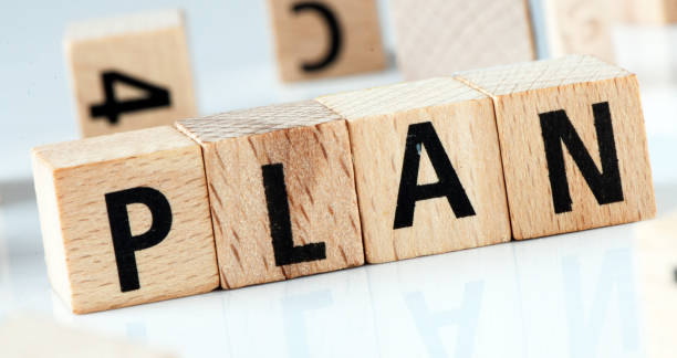 istock PLAN word arranged with wooden letters on a white background. 2155764373