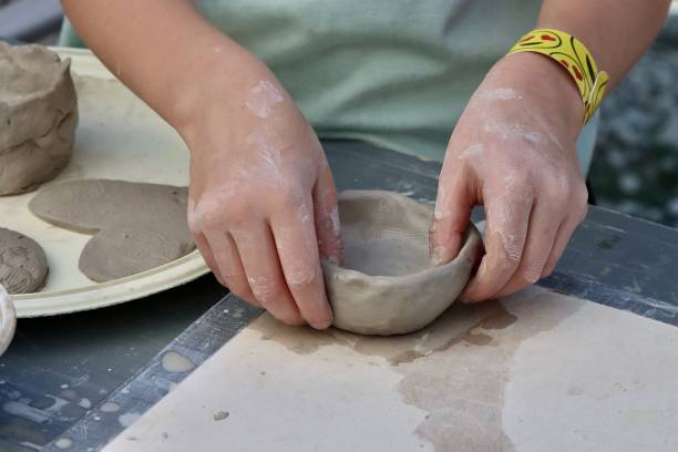 istock Child Forming A Clay Bowl 2155764639
