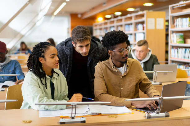 istock Two students are being helped by their professor 2155774632