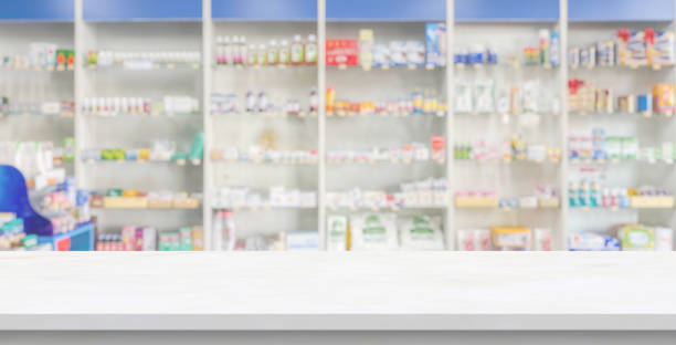 istock Empty white marble counter top with blur pharmacy drugstore shelves background 2155774754