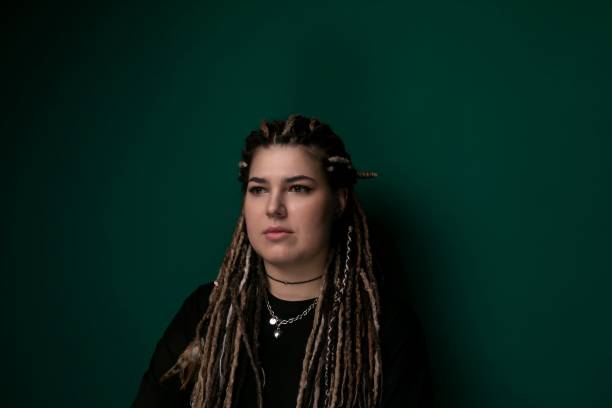 istock Woman With Dreadlocks in Front of Green Wall 2155774880