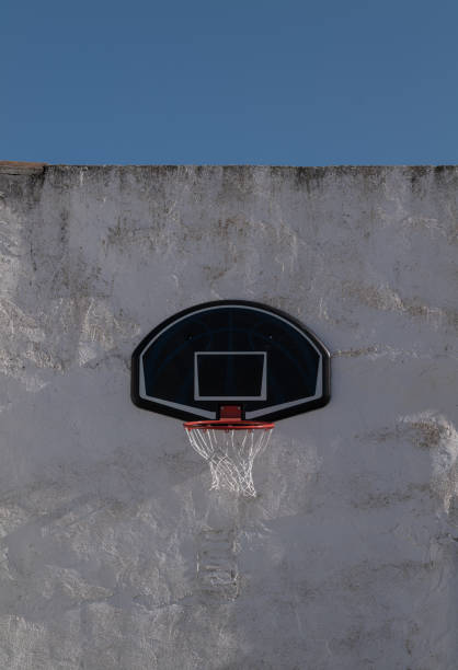 istock basketball backboard on white wall against sky 2155775824