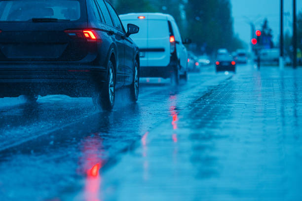 istock Splashes of water from passing car. Wet road. 2155779150