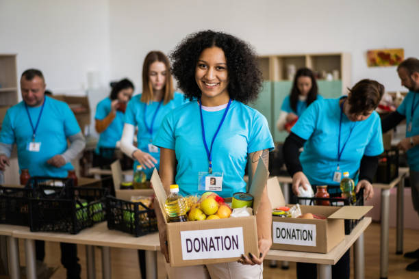 istock A female aid worker holding a food donation box 2155780470