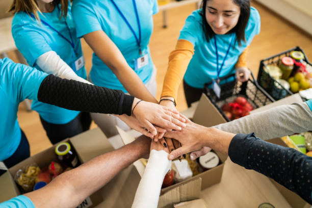 istock Looking from above at outstretched arms with the hands stacked together 2155780474