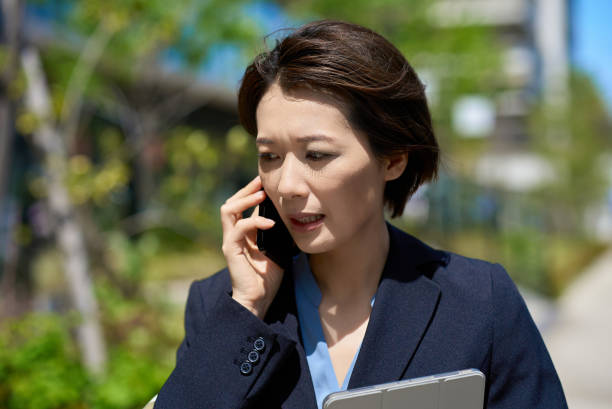 istock A woman talking on the phone with a troubled expression 2155781833