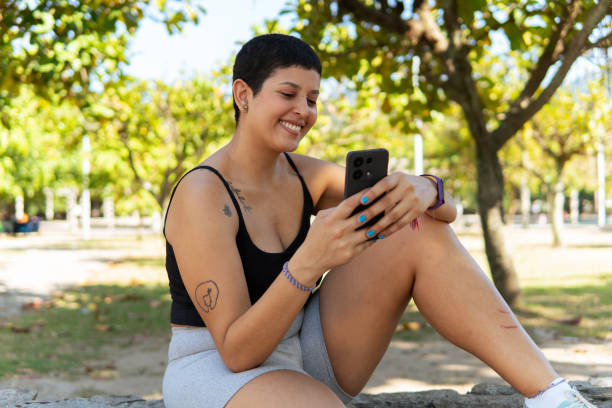 A young woman interacting with her phone outdoors in Rio de Janeiro Brazil