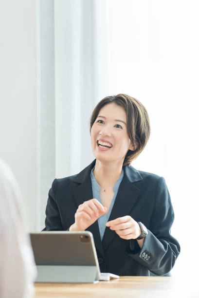 istock A woman in a suit explaining to a woman in plain clothes 2155783113