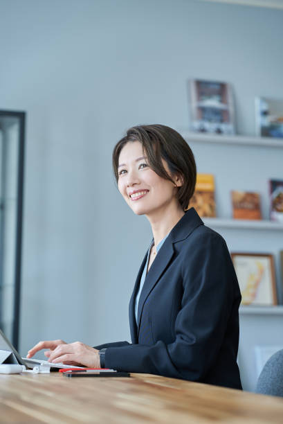 istock A woman in a suit sitting in front of a tablet PC 2155783289