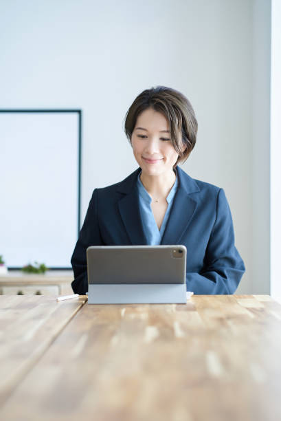 istock A woman in a suit working in a room 2155783621