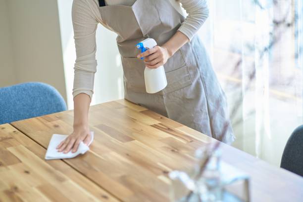 istock A woman wiping down a room 2155784456