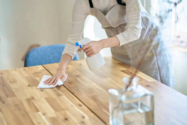 istock A woman wiping down a room 2155784490