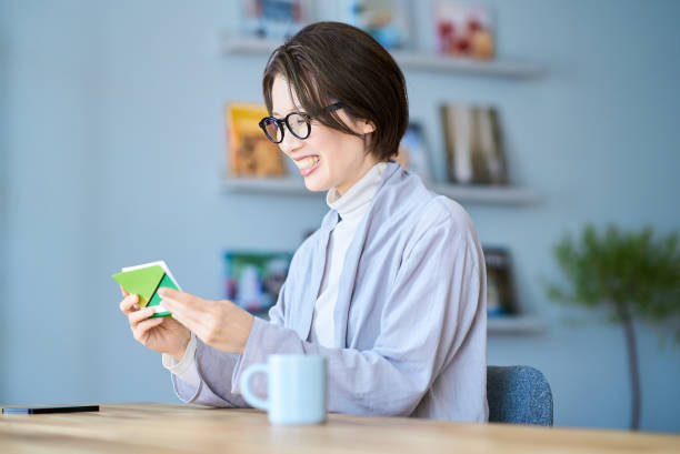 istock Woman looking at bank account passbook 2155784613
