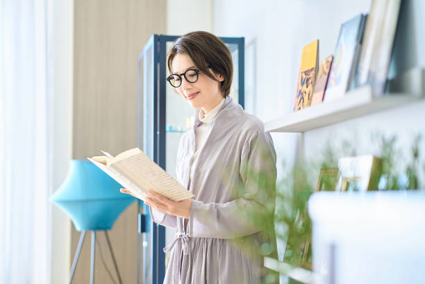 istock woman reading in the room 2155784640