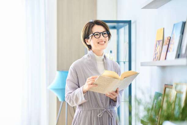 istock woman reading in the room 2155784646