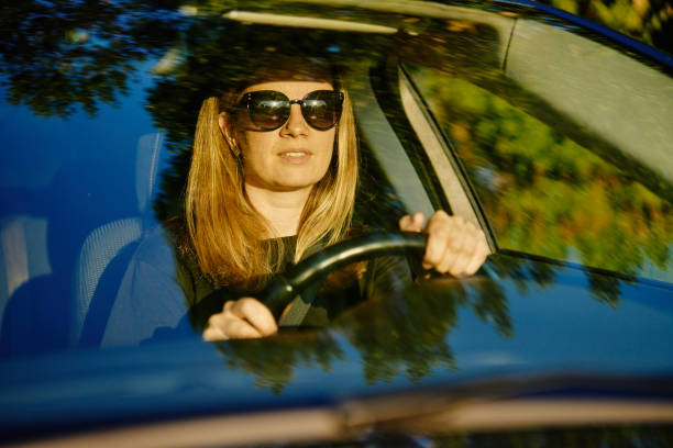istock Happy woman is sitting in car. View through windshield 2155785697