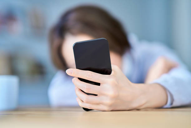 istock A woman operating a smartphone looking tired 2155785723
