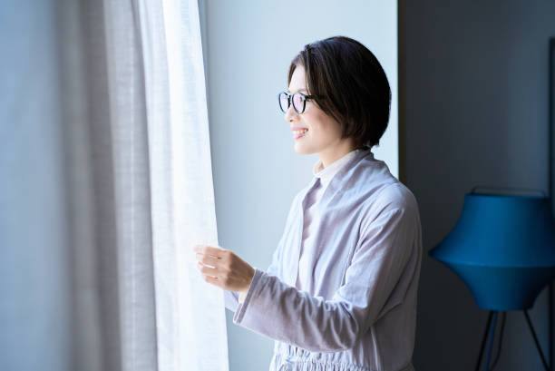 istock A woman smiling in the morning light 2155785850