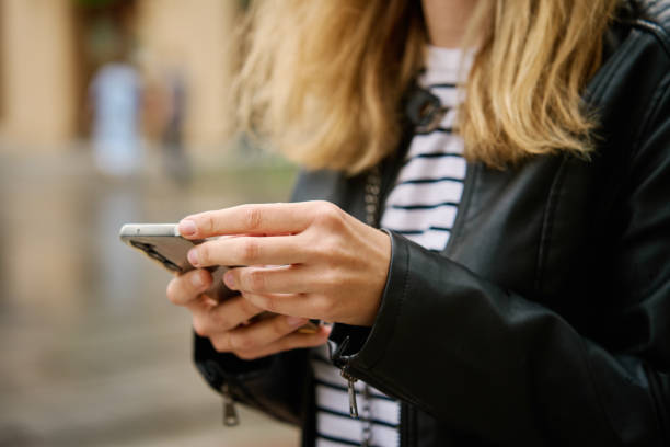 istock Woman using smartphone at city street 2155786437