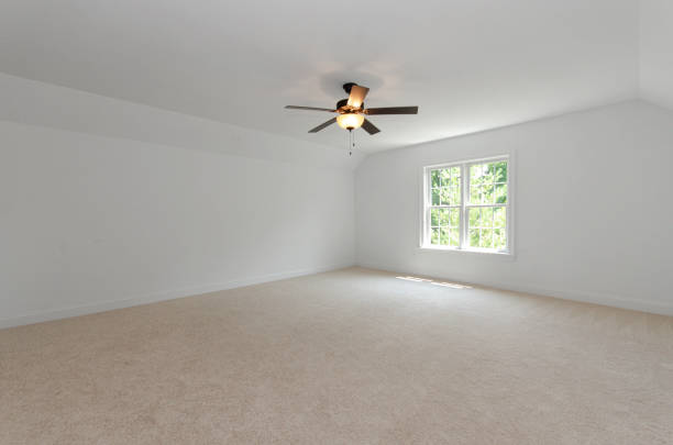 istock Empty Carpeted Room with Ceiling Fan and Window 2155786715