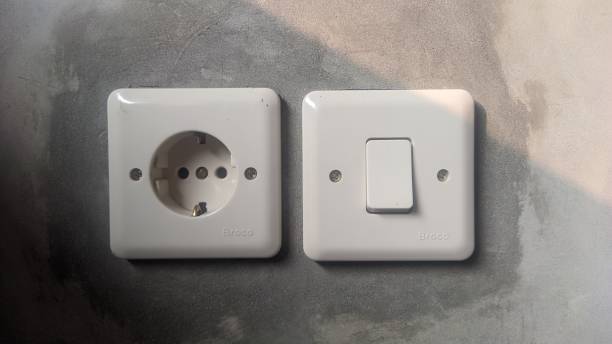 istock electric power outlet and power switch on the wall 2155787221