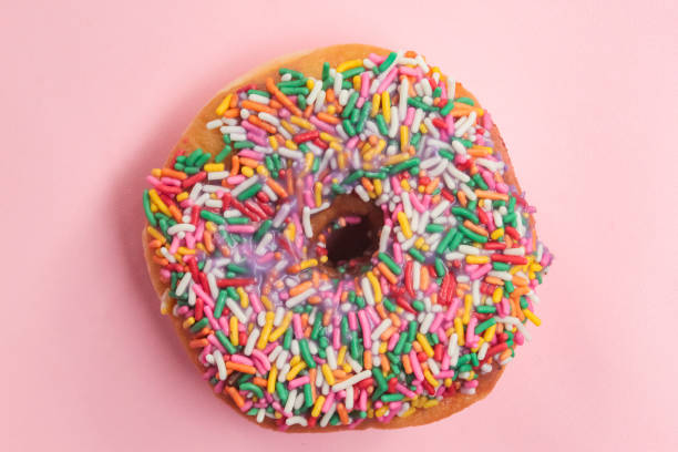 istock a donut with colorful chocolate sprinkles on a pink background 2155788135