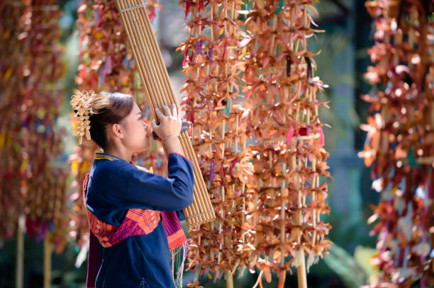 girl in folk costume with folk music called Kaen or can In Wat Wang Kham, Kalasin Province, Thailand