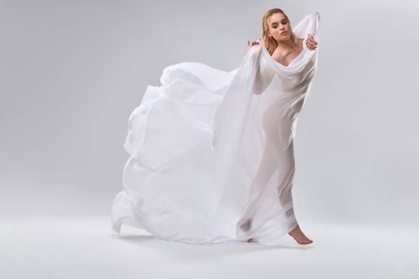 istock Young nude woman dancing with white veil in her hands 2155789585