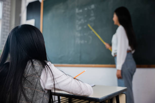 istock A woman is teaching a child in a classroom 2155795523