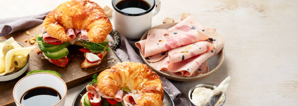 istock Croissant with ham and cheese on board and plate. Breakfast concept. 2155797515