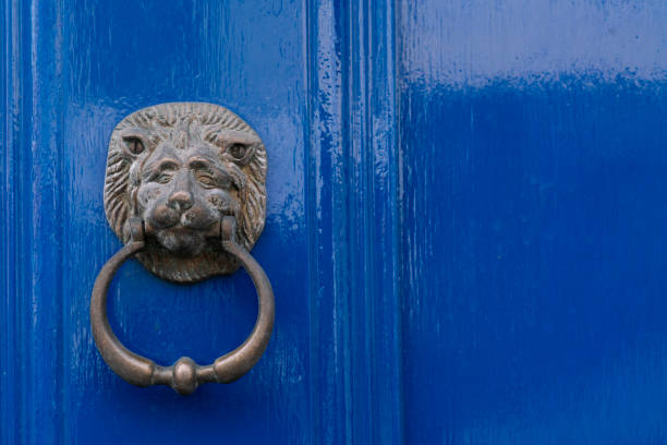 istock Old-fashioned steel knocker on the blue door, close up 2155800885