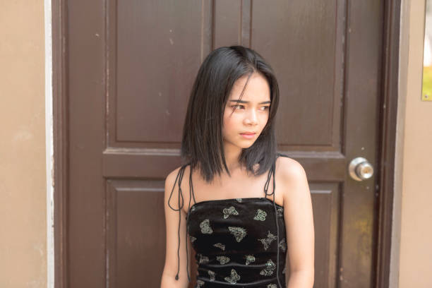 istock A bothered young lady looks to the side with an annoyed expression. 2155800936