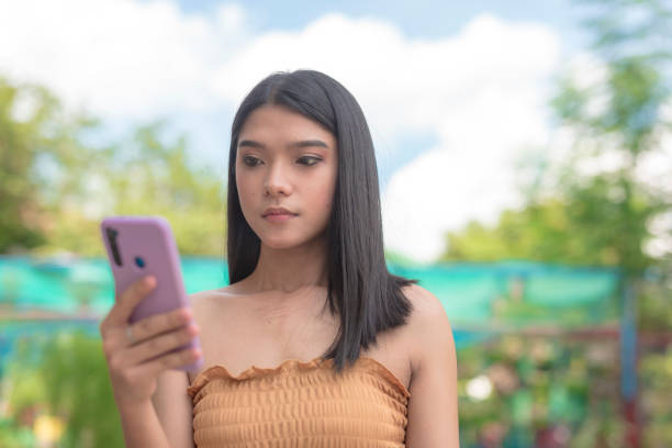 istock A serious woman looks unenthusiastic while looking at her phone. Disappointed at her likes and comments. Feeling unloved. 2155802232