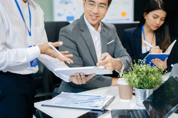istock Happy Asian businesspeople while collaborating on a new project.  using a laptop and tablet 2155802560