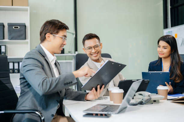 istock Happy Asian businesspeople while collaborating on a new project.  using a laptop and tablet 2155802576