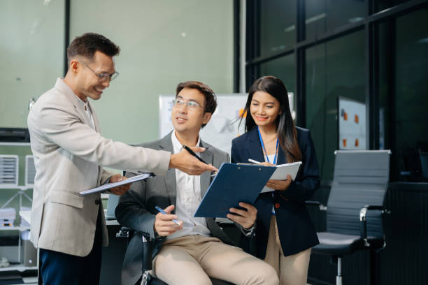 istock Happy Asian businesspeople while collaborating on a new project.  using a laptop and tablet 2155802582
