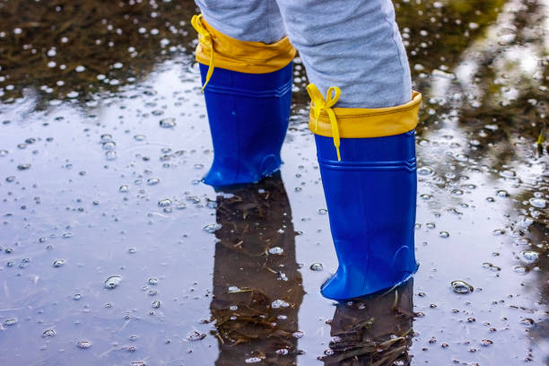 People protected with rubber boots in a flooded environment