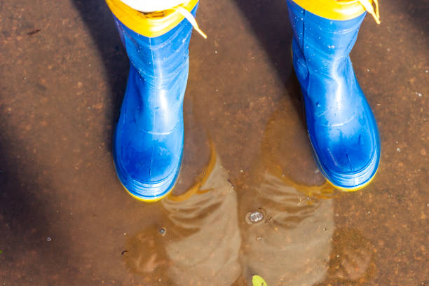 People protected with rubber boots in a flooded environment