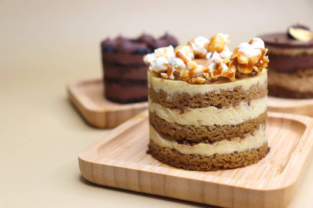 istock Assorted Seasonal mini cakes. Hazelnut, Opera, Salted Caramel, and Double Chocolate. Endless variety, easy serving, moist layers, rich frosting. A symphony of flavor in every bite. Bakery products. 2155804850