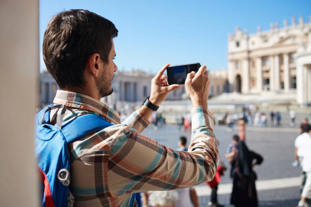 istock Young male tourist using phone while exploring big city 2155805550