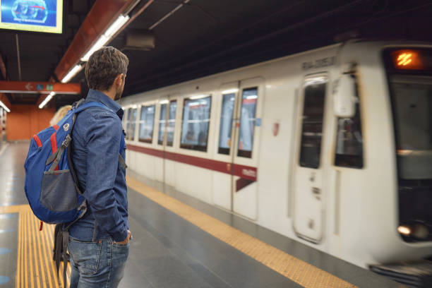 istock Young male tourist waiting for a train 2155805615