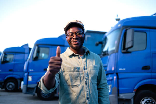 istock Professional driver and fleet of trucks parked in background. 2155805890