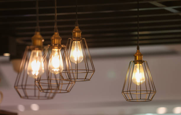 istock A group of four lighted lamps hanging from the ceiling 2155807048
