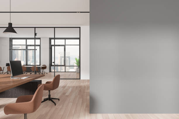 istock Modern business interior with desk and armchairs in row, window. Mockup wall 2155808553