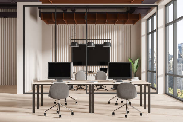 istock Modern open office space with computers on desks and ergonomic chairs, light wooden floor, concept of workspace design. 3D Rendering. 2155808578