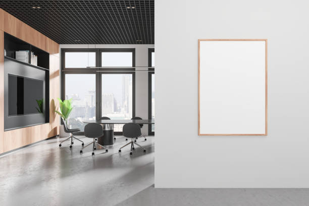 istock Cozy office interior with meeting table and tv screen, window and mockup frame 2155809205