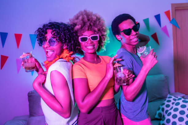 istock Three happy multi-ethnic friends partying at home 2155809911